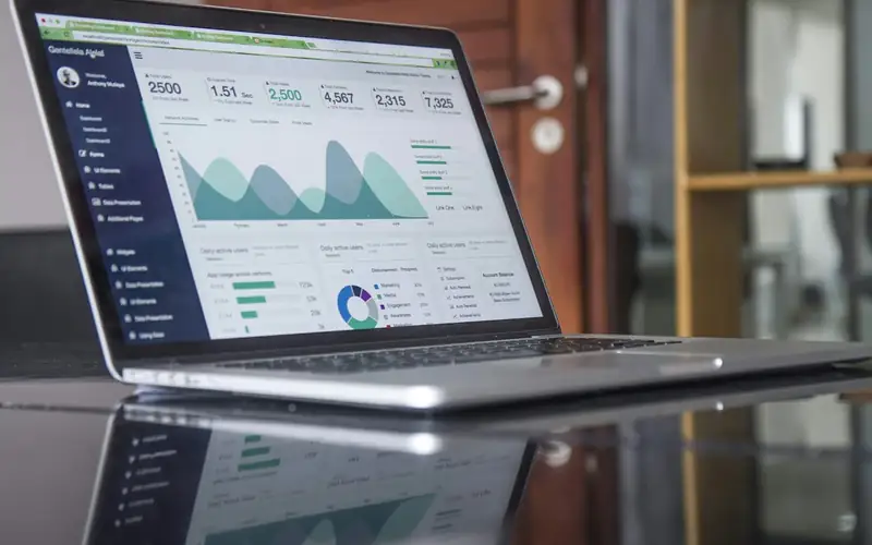 Sales and menu performance reports for restaurant order management reviewed on a laptop