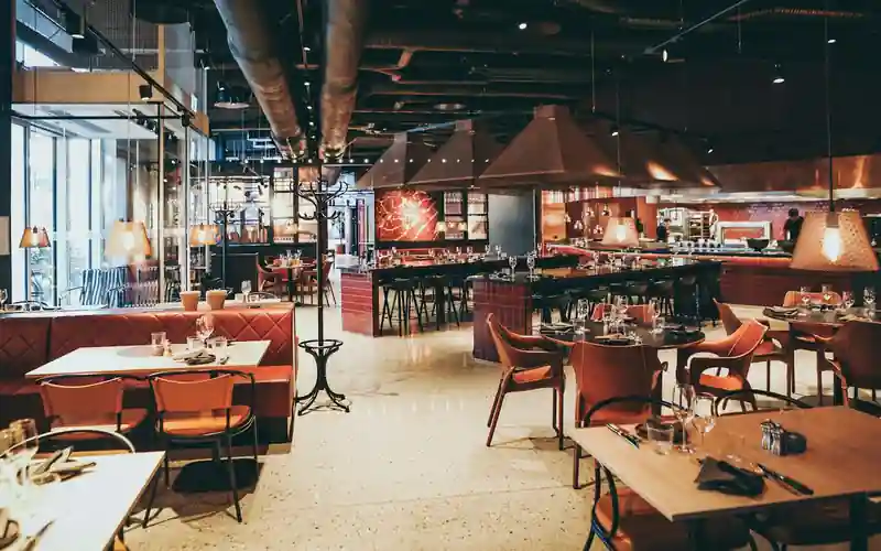 Restaurant order management system — dining room served by a digital menu and POS